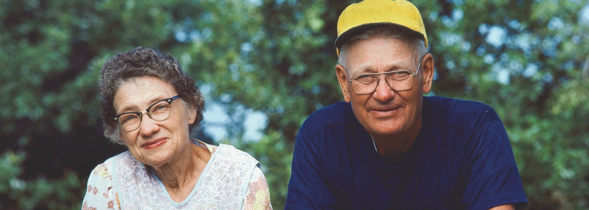couple leaning on fence