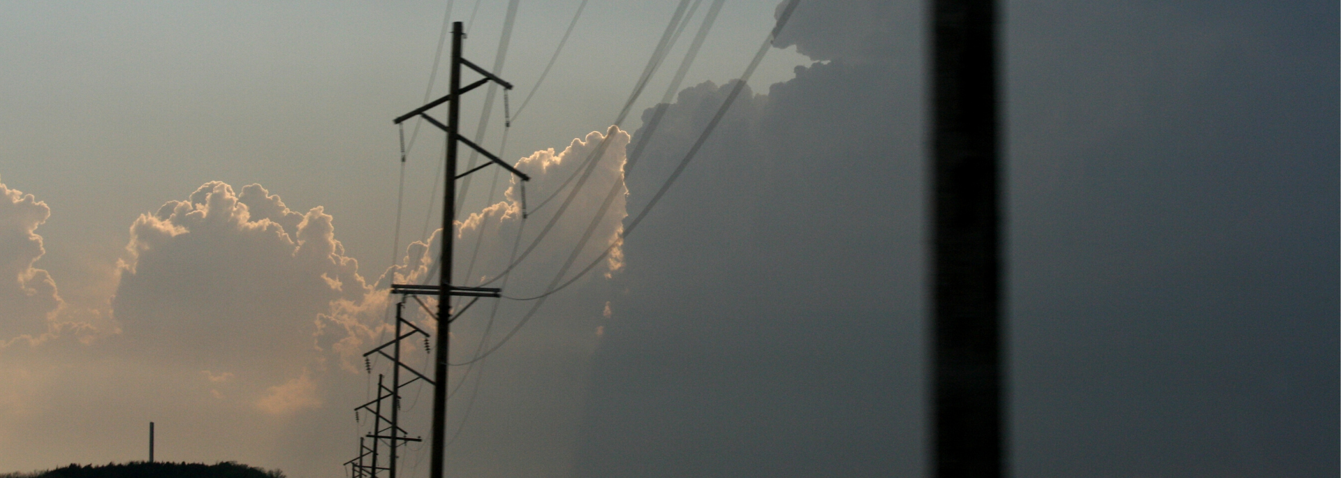 Storm clouds behind power lines Storm clouds behind power lines