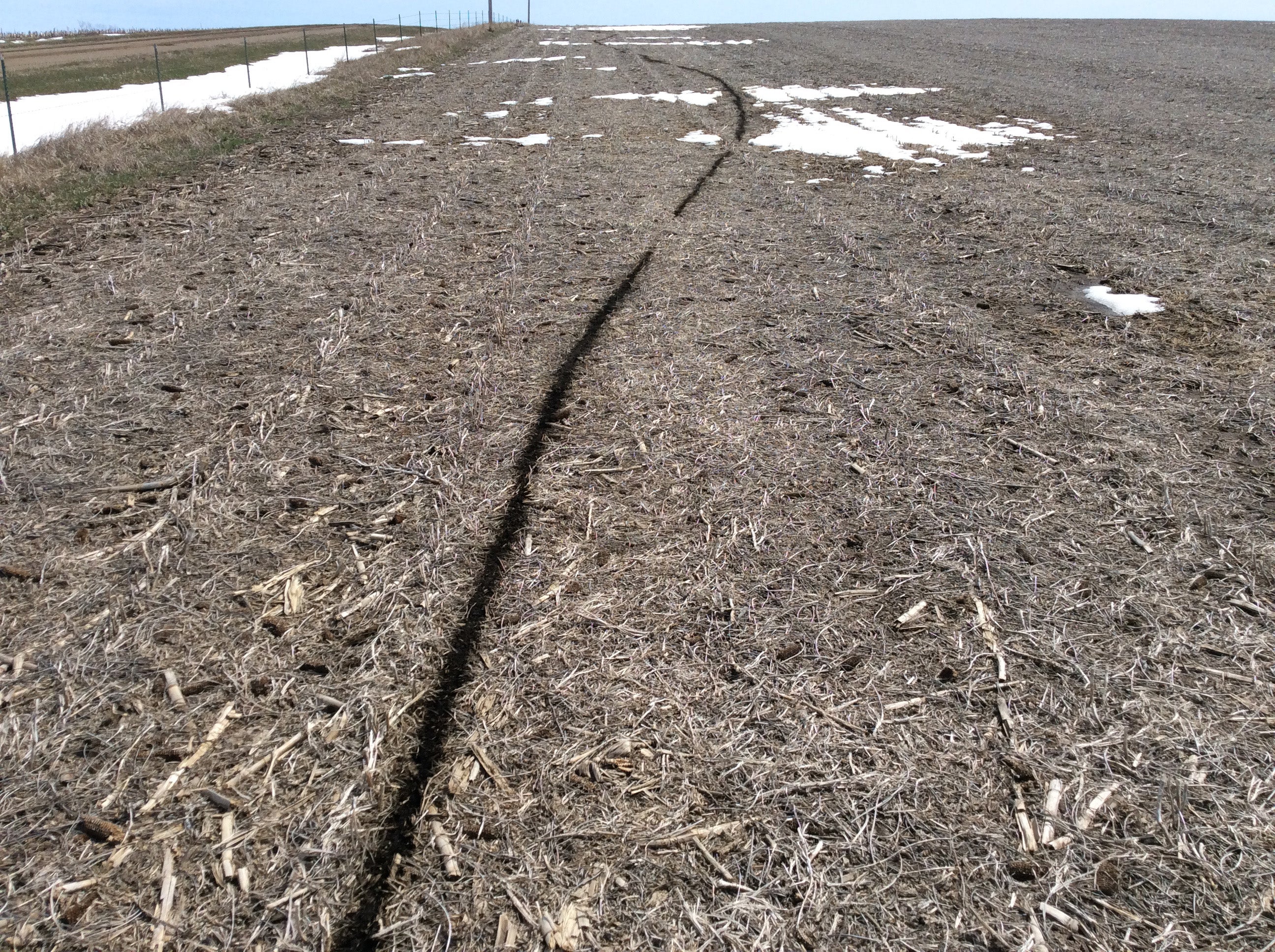 A downed line burned a trench into the ground through the snow